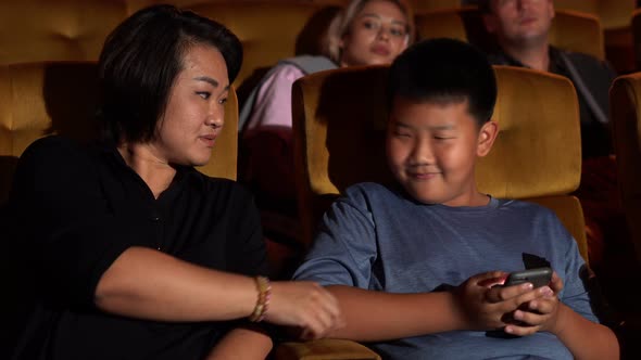 The Boy Playing Game with a Mobile Phone alt