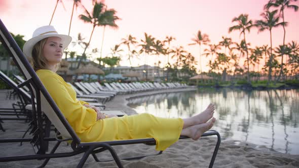 Young Woman Traveler Relaxing at the Resort Pool Traveling for Summer Vacation alt