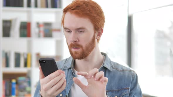 Excited Man Enjoying Success While Using Smartphone alt