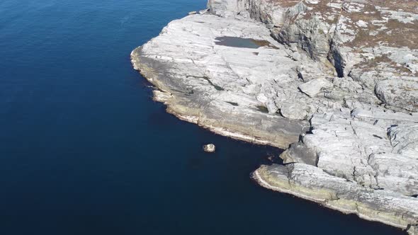 Aerial view of the sea wave and rocks of the coastline of Norway alt