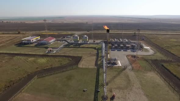 Petroleum Plant with Flare Stack in Field, Aerial Shot, Oil and Gas Industry