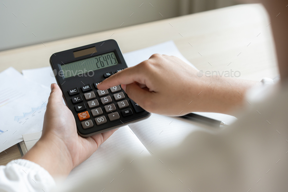 Woman calculate bill budget payment, home accounting concept with calculator.