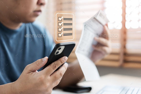 Asian man worried looking at monthly bills payment