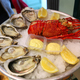 Large dish with fresh seafood, oysters with lobster with lemon and sauce on ice - PhotoDune Item for Sale