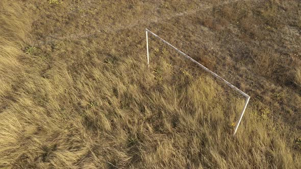 Soccer goal on abandoned terrain 4K aerial video alt