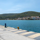 Greece, Megalochori, Milos, Miloi port, Agistri island. Harbor with bollard, calm sea, blue sky. - PhotoDune Item for Sale