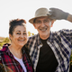 Happy senior farmer couple looking at camera at rural field farm - Small business agriculture and ha - PhotoDune Item for Sale
