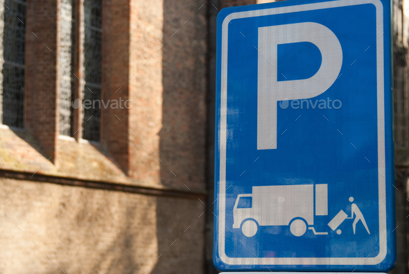 Closeup shot of a blue parking sign in an urban city street Stock Photo by  wirestock