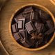 Cubes of dark artisan chocolate in a wooden bowl. Bitter chocolate - PhotoDune Item for Sale