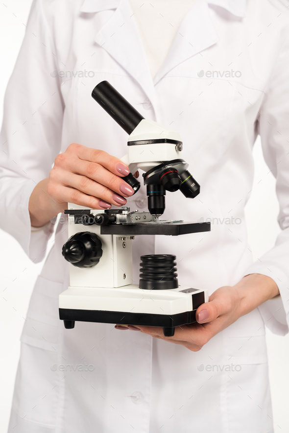 cropped view of scientist holding microscope isolated on white Stock