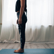 silhouette of woman in sportswear standing on mat ready to do exercises - PhotoDune Item for Sale