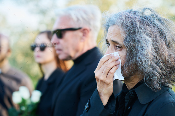 people crying at a funeral