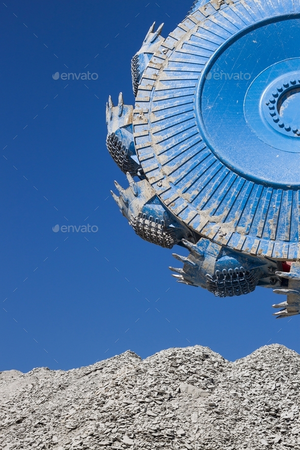 Vertical shot of a rotary wheel excavator on blue sky background
