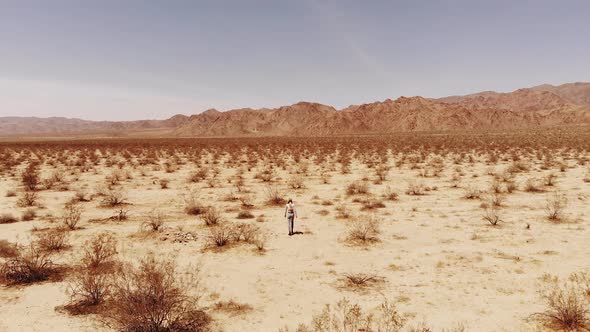 Girl Walking In The Desert Aerial