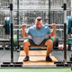 Strong sportsman doing squat exercises in gym light with barbell - PhotoDune Item for Sale