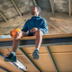  young black man with a basketball posing in an industrial warehouse. Sports concept. - PhotoDune Item for Sale