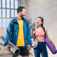 Cheerful male and female athlete standing together at gym. Smiling woman and male friends. - PhotoDune Item for Sale