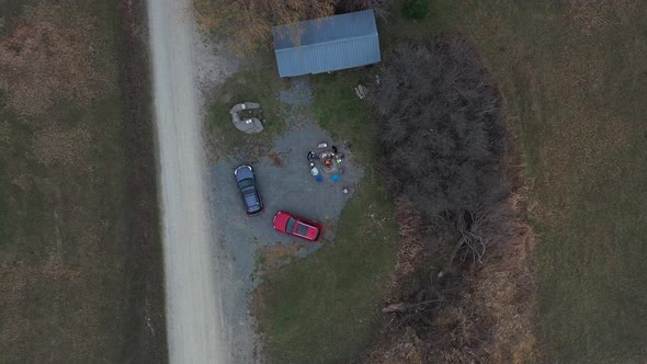 Zoom Out Top Down Aerial View of People Resting in a Circle by the Fire Enjoying Camping in the Wild alt