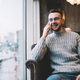 Cheerful bearded man talking on smartphone - PhotoDune Item for Sale