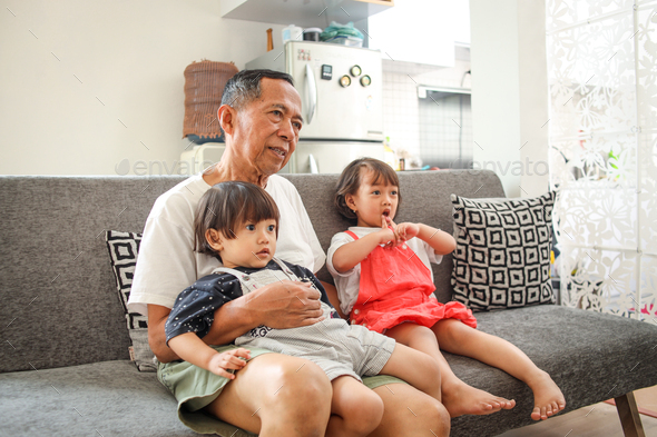 grandpa watching tv with his grandchild
