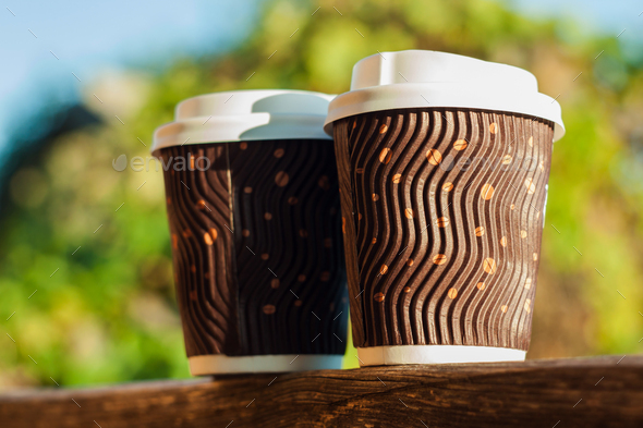 Two coffee cups balcony natural daylight blurred background. Beverages shop discount Hot drink to go