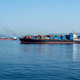 Container cargo ship loaded moored in Mediterranean sea, Greece. Ship leaves Piraeus port. - PhotoDune Item for Sale
