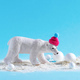 Cute little model of white bear in knitted hat with snowballs on blue background.  - PhotoDune Item for Sale