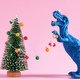 Happy cute blue dinosaur decorate Christmas tree with retro bulb garland.  - PhotoDune Item for Sale