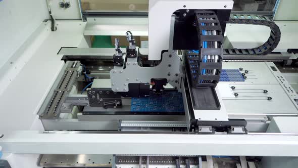 The Engineer Works for the Surface Mount Technology Machine