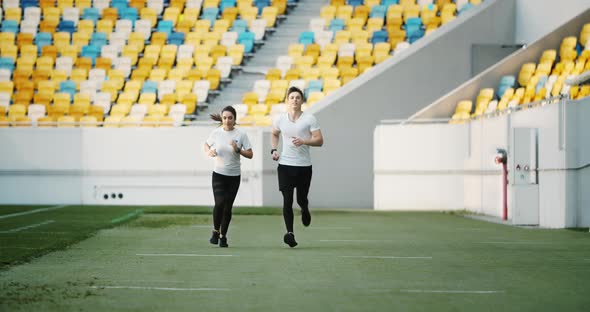 Couple of Joggers on Stadium