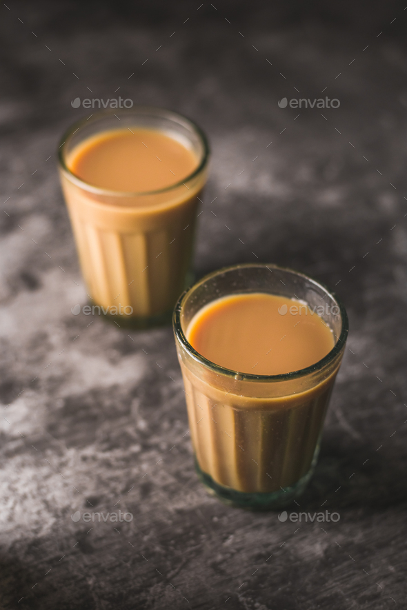 Indian chai in glass cups with masalas to make the tea. Stock