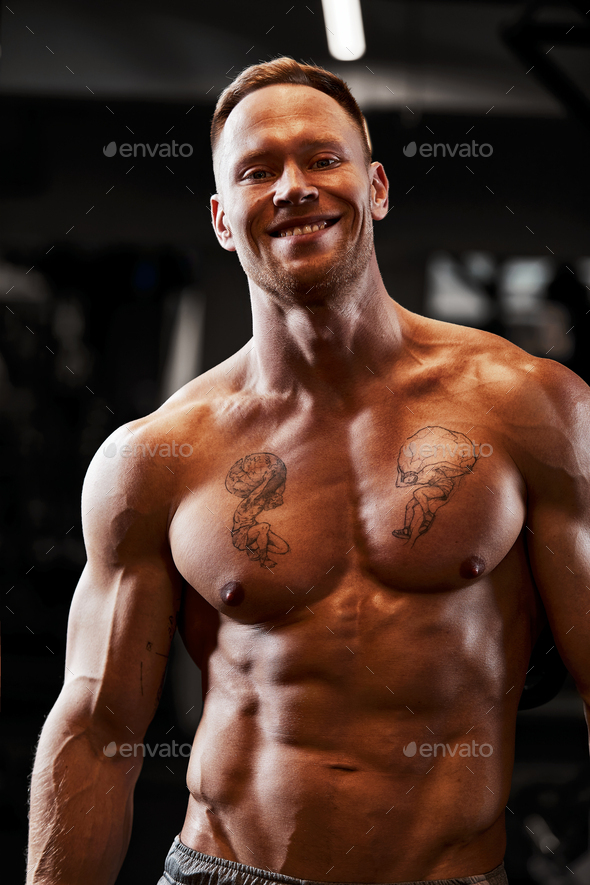 Powerful Bodybuilder Doing The Exercises With Dumbbells Photo Of Strong Male With Naked Torso