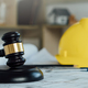 Labor and Construction law concept.judge gavel with yellow safety hat,blueprint,home model backgound - PhotoDune Item for Sale