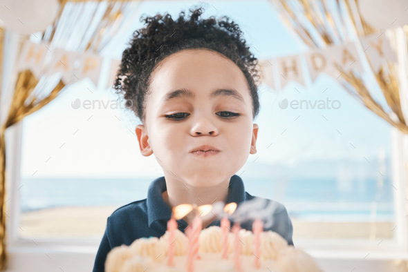 Cake, face and girl child blowing candles at birthday, celebration or special event in her home. Pa