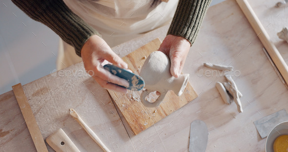 Creative, pottery and design with hands of woman in workshop studio for  molding, ceramics and art. Stock Photo by YuriArcursPeopleimages