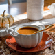 Closeup of a bowl of pumpkin soup on a dining room table - PhotoDune Item for Sale