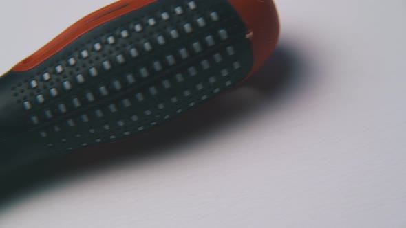 Motion Past Crosshead Screwdriver Lying on White Surface alt