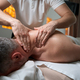 Masseur giving upper back massage to client - PhotoDune Item for Sale
