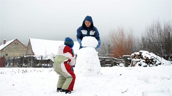 Father Making A Snowman 