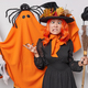 People and October holiday concept. Funny woman makes grimace wears wizard hat and dress poses with - PhotoDune Item for Sale