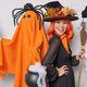 Happy Halloween concept. Positive woman with orange hair dressed like wizard poses with broom and - PhotoDune Item for Sale