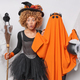 Shocked curly haired young woman poses near orange ghost holds broom with crow prepares for - PhotoDune Item for Sale