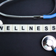 stethoscope and alphabet letters with the word wellness.  - PhotoDune Item for Sale