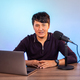 Portrait of asian man recording a video blog in a studio with microphone - PhotoDune Item for Sale