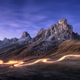 Car light trails on mountain road and high rocks at night - PhotoDune Item for Sale