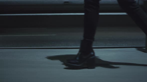 Woman Legs Walking Highway at Late Night Dark Road with Passing Cars alt