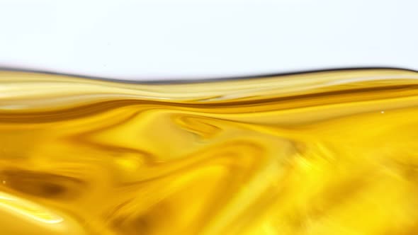 Super Slow Motion Shot of Moving Oil Waves Isolated on White Background at 1000Fps alt