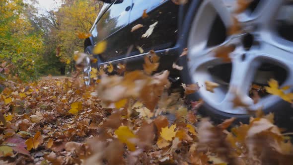 Black SUV Crossing Through Alley with Sunlight at Background alt