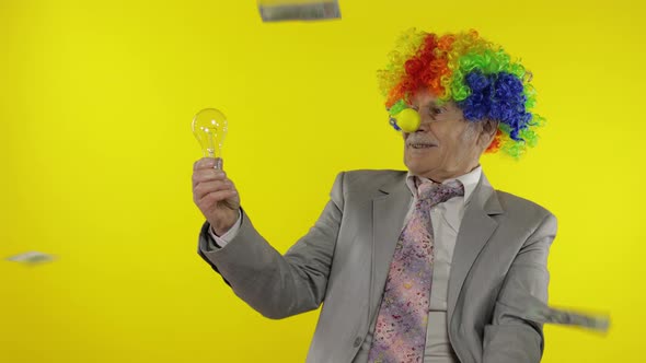 Senior Clown Businessman Entrepreneur Show Light Bulb. Came Up with Great Idea alt