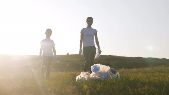 Care About Nature. Volunteer Group Collects Trash in the Trash Bag. Trash-free Planet Concept alt